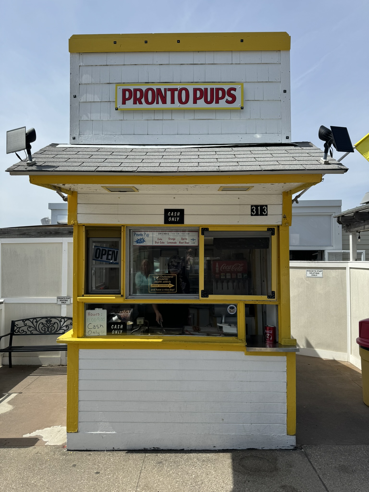 Proto Pups corn dog stand, sign says “Cash Only”.