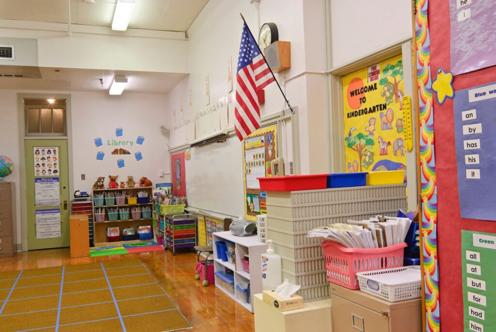 Elementary school classroom with American flag on the wall.