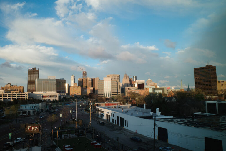 View of downtown Detroit skyline with skyscrapers and construction crane.