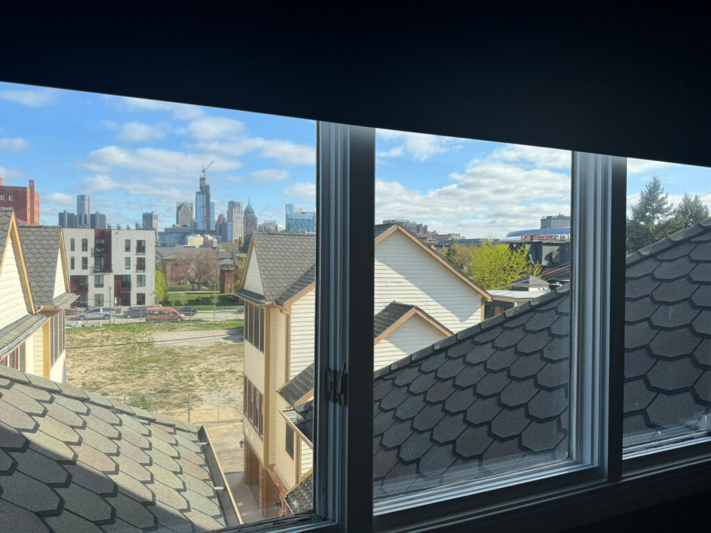 View of downtown Detroit skyline from within a residential building.
