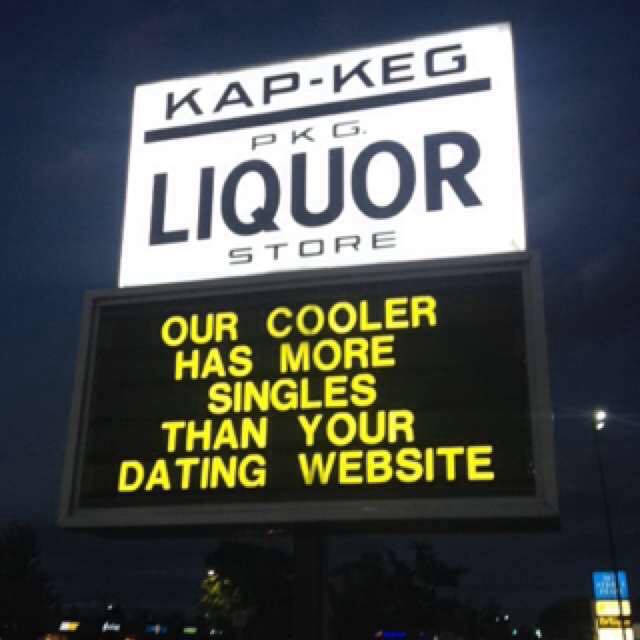 Sign outside of the "Kap-Keg PKG Liquor Store" reading: "OUR COOLER HAS MORE SINGLES THAN YOUR DATING WEBSITE."