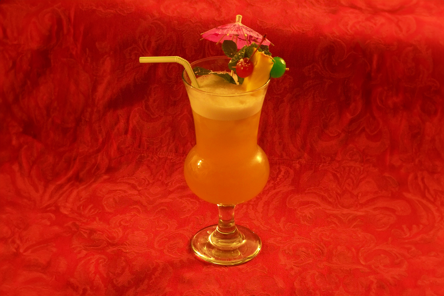 Photo of Zombie cocktail with parasol and straw.