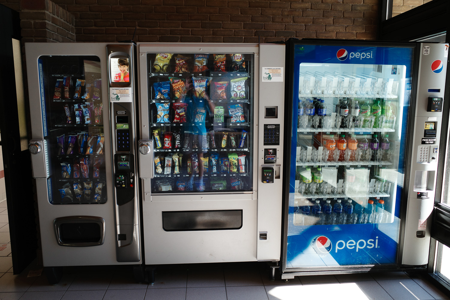 Vending machines filled with snacks and soda at a Michigan highway rest stop.