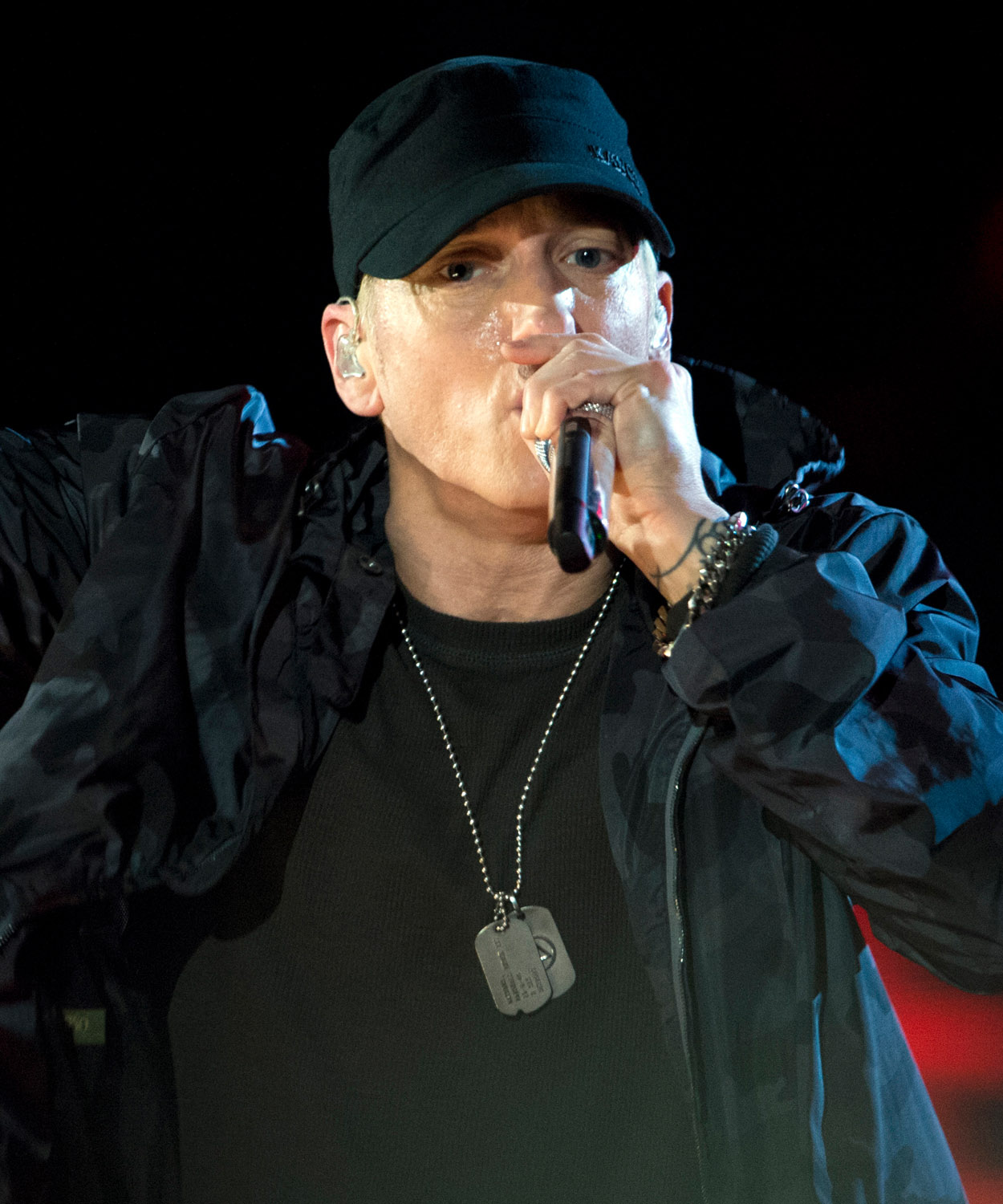 Close up photo of Eminem rapping in concert.