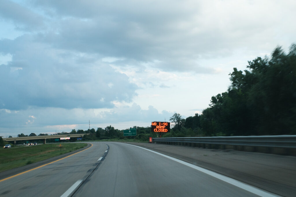 A highway with sign “WB I-96 Closed”