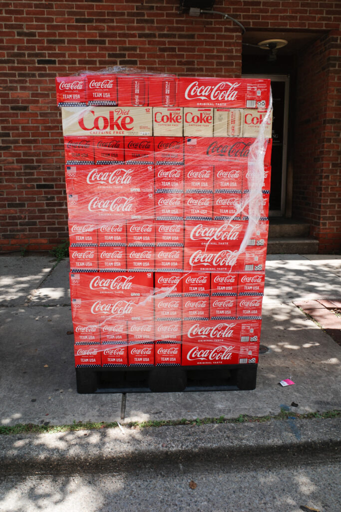 Large truck pallet of Coca-Cola cans in packages.