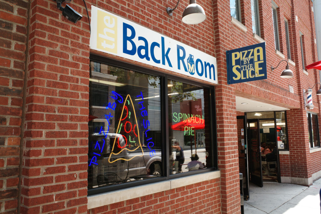 Exterior of Backroom Pizza with Backroom Pizza sign.