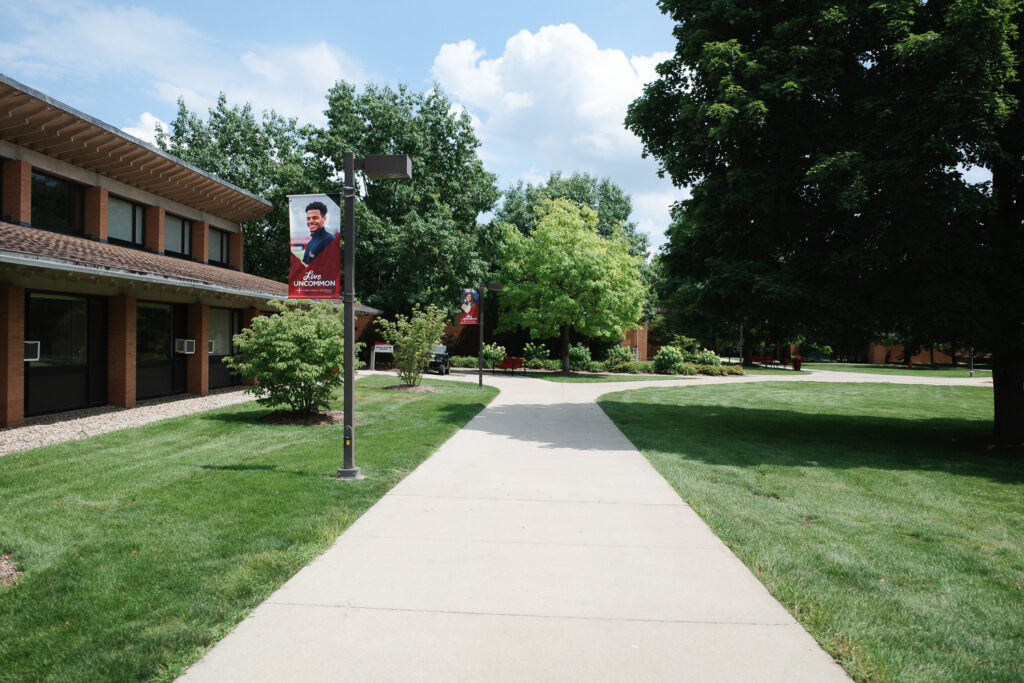 Banners with student portraits reading "Live Uncommon."