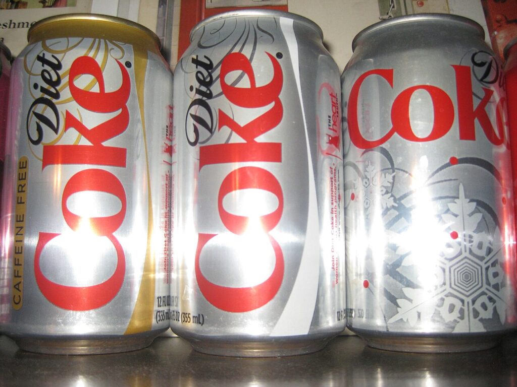 Three variety cans of diet coke, one caffeine free.