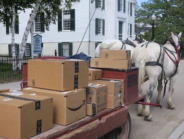 A horse and cart carrying Amazon packages.