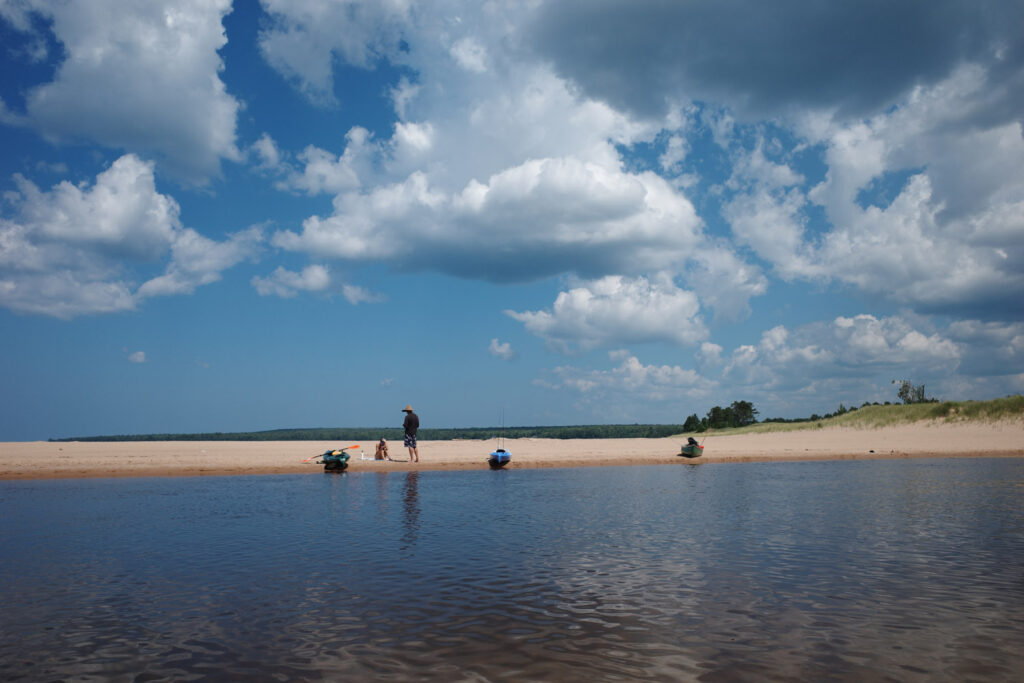 Kayakers gathering on beach.