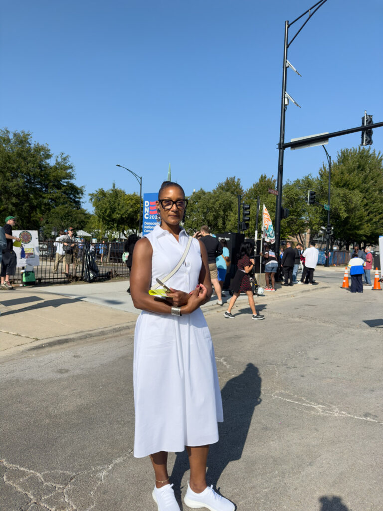 African-American woman in glasses standing outside DNC.