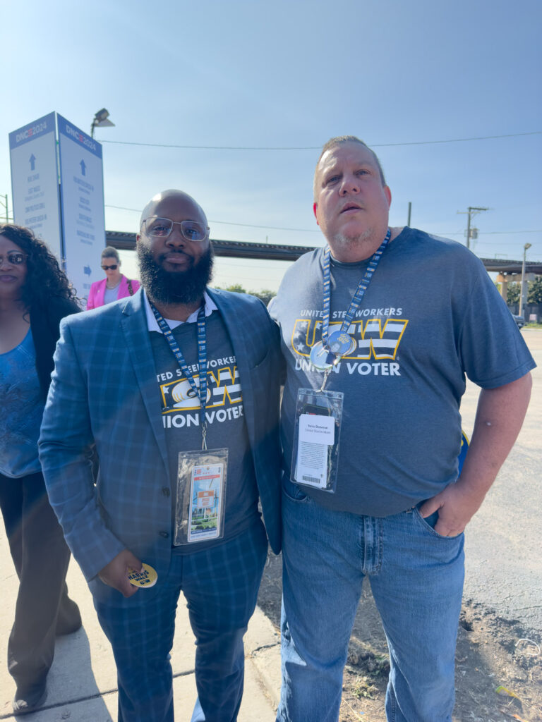 African-American man and White man with UAW "United Steel Workers, Union Voter" shirts outside DNC.