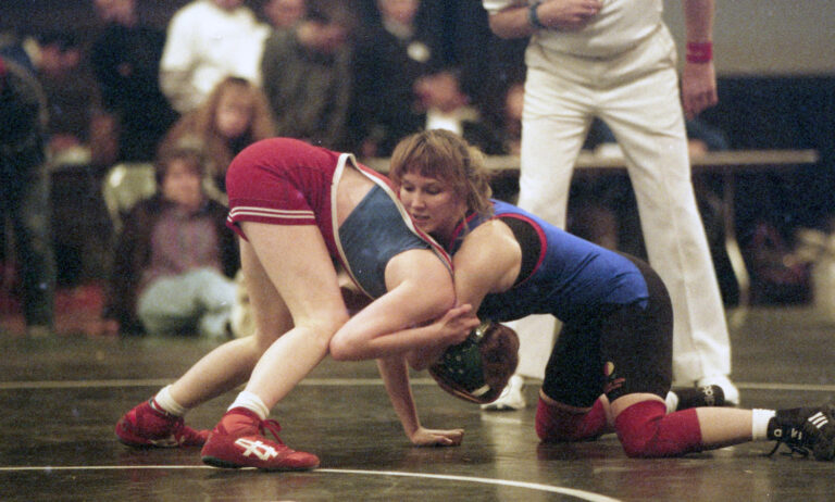 Women's wrestling match, wih Tricia holding opponent in a lock.