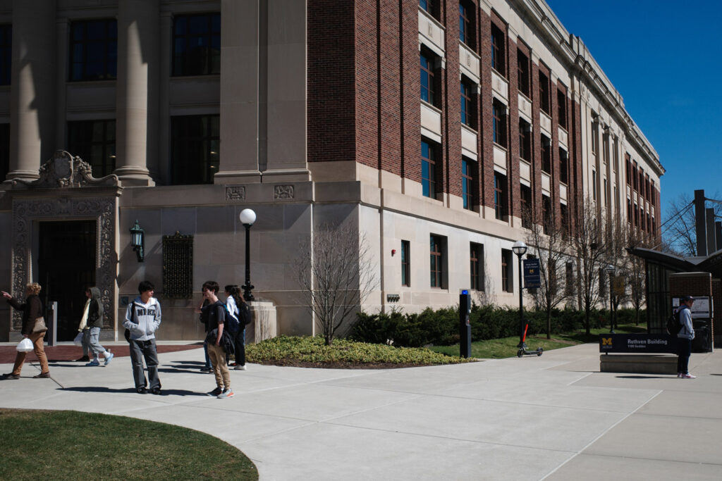 Students talking outside Ruthven Hall in Ann Arbor.