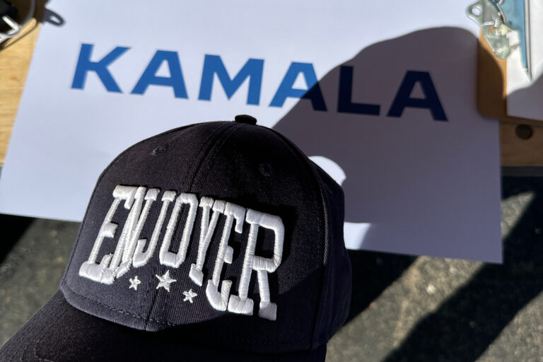 Michigan Enjoyer hat casting shadow over Kamala poster.