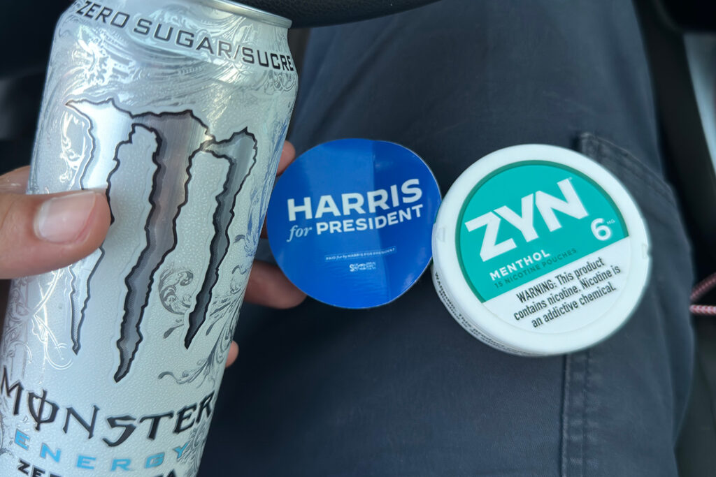 White Monster Zero Sugar energy drink and Zyn menthol 6mg on Mitch's lap next to Harris for President sticker.