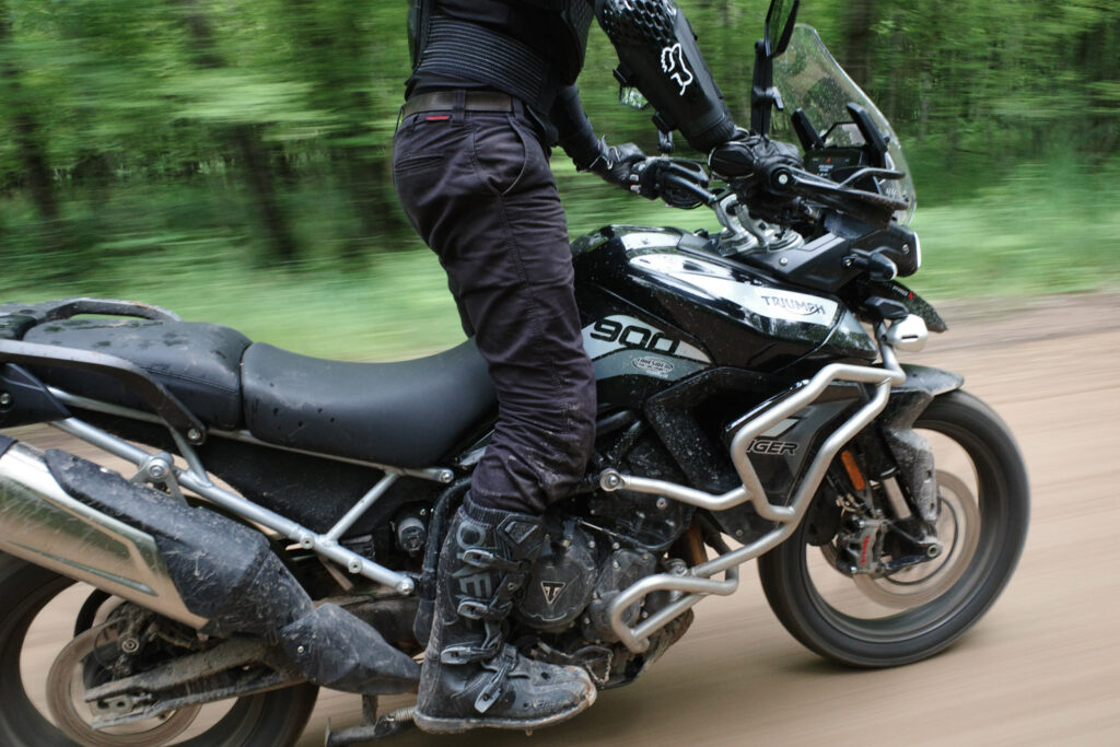 Man in standing position on fast moving motorcycle.