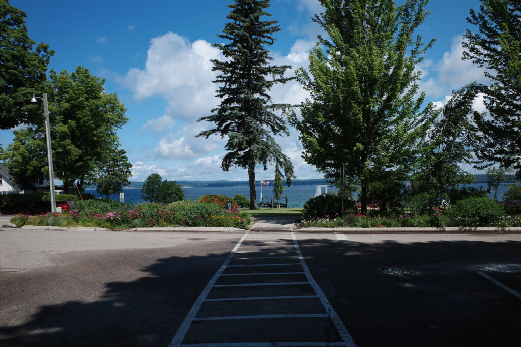 Street with view of bay and American flag in distance.