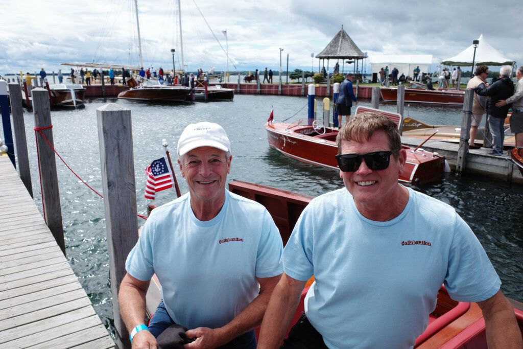 Mike and George smiling in front of their boat "Collaboration."