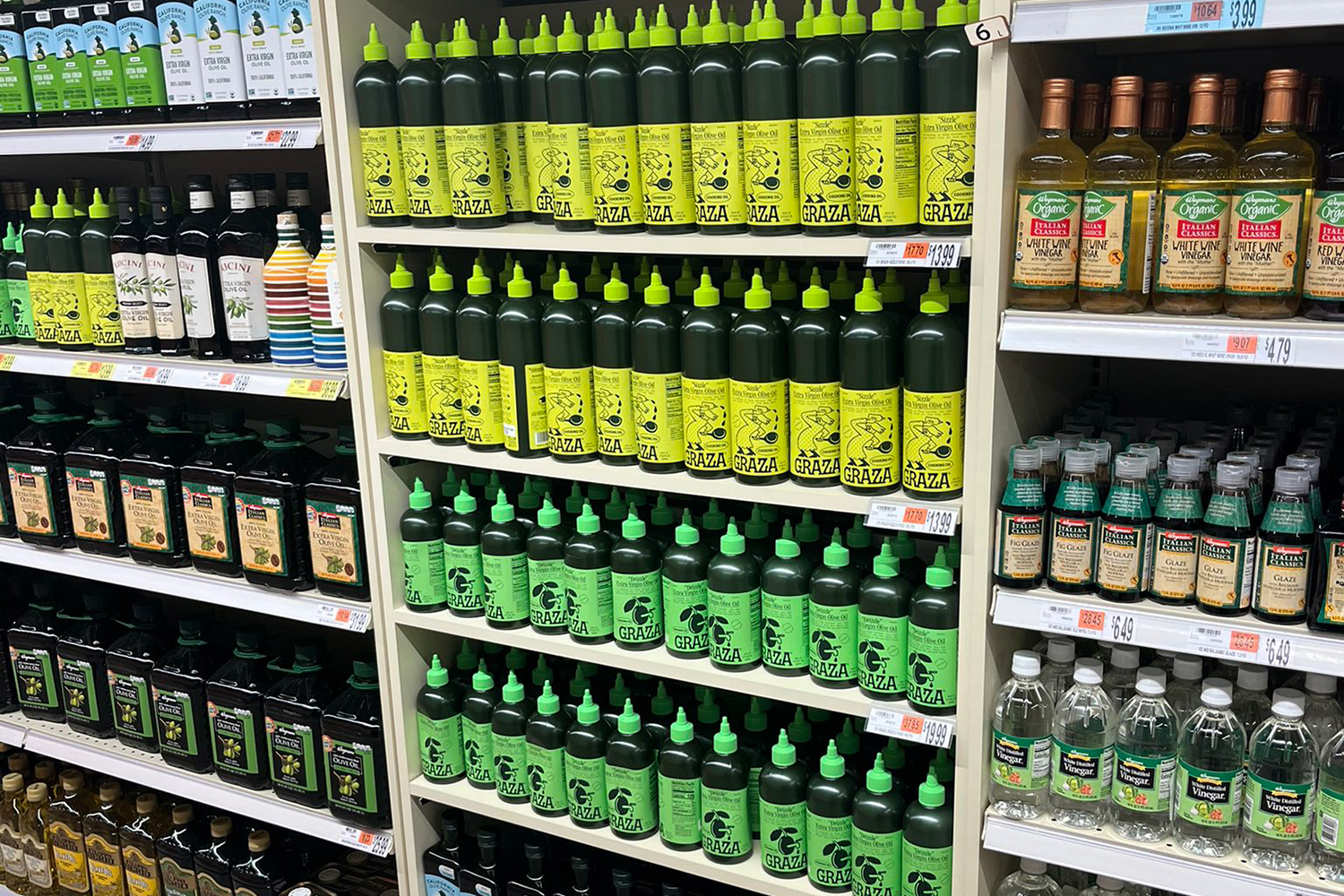 Graza olive oil varieties on their own shelf in store.