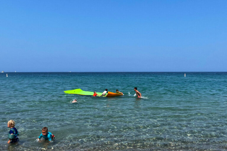 Kids playing on raft in Lake Michigan.