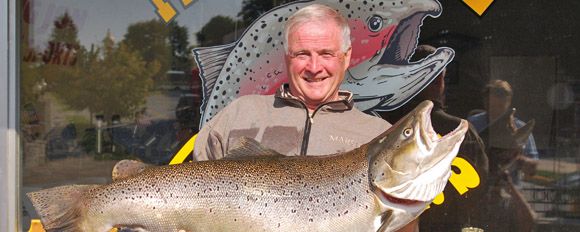 Man holding massive fish and smiling.