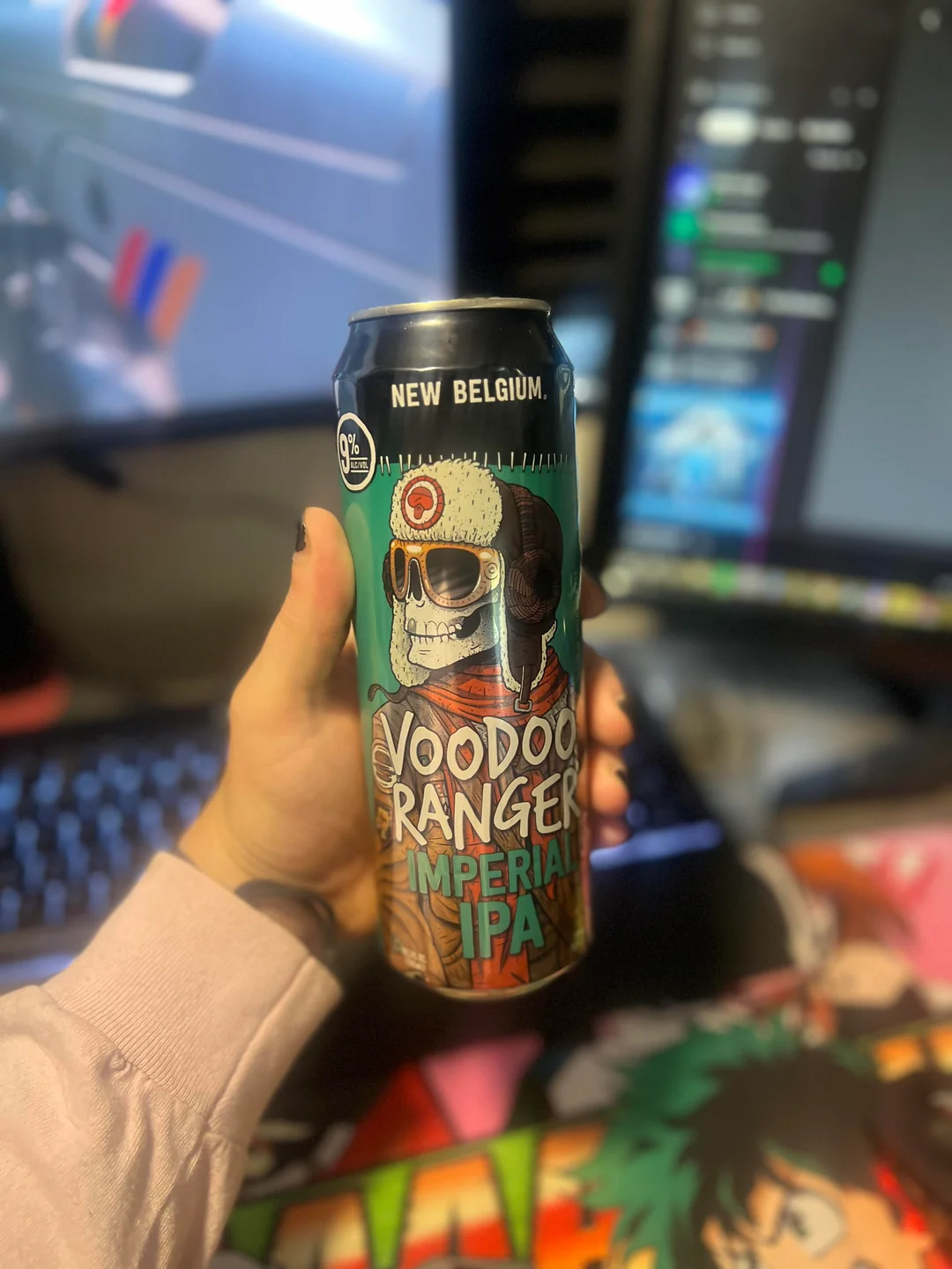 Hand holding can of Voodoo Ranger Imperial IPA with PC in background.