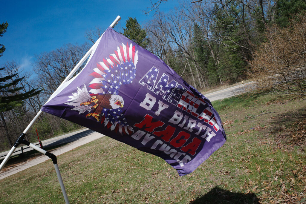 Purple flag reading "American by birth, MAGA by choice"