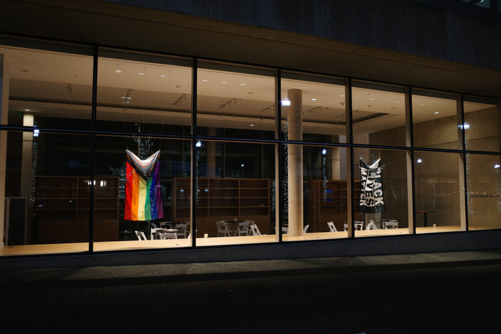 Pride Progress and Black Lives Matter flags hanging inside Grand Rapids Art Museum.