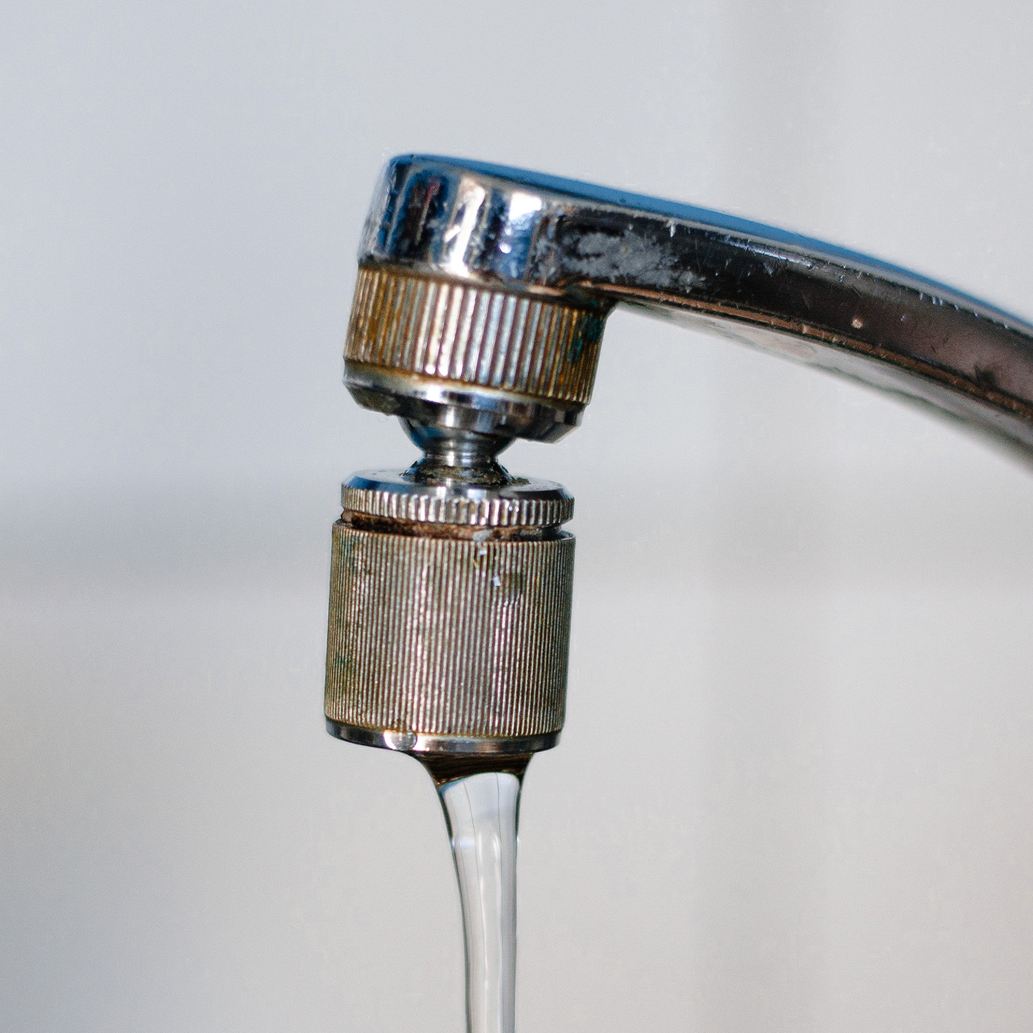 Tap water draining from faucet.