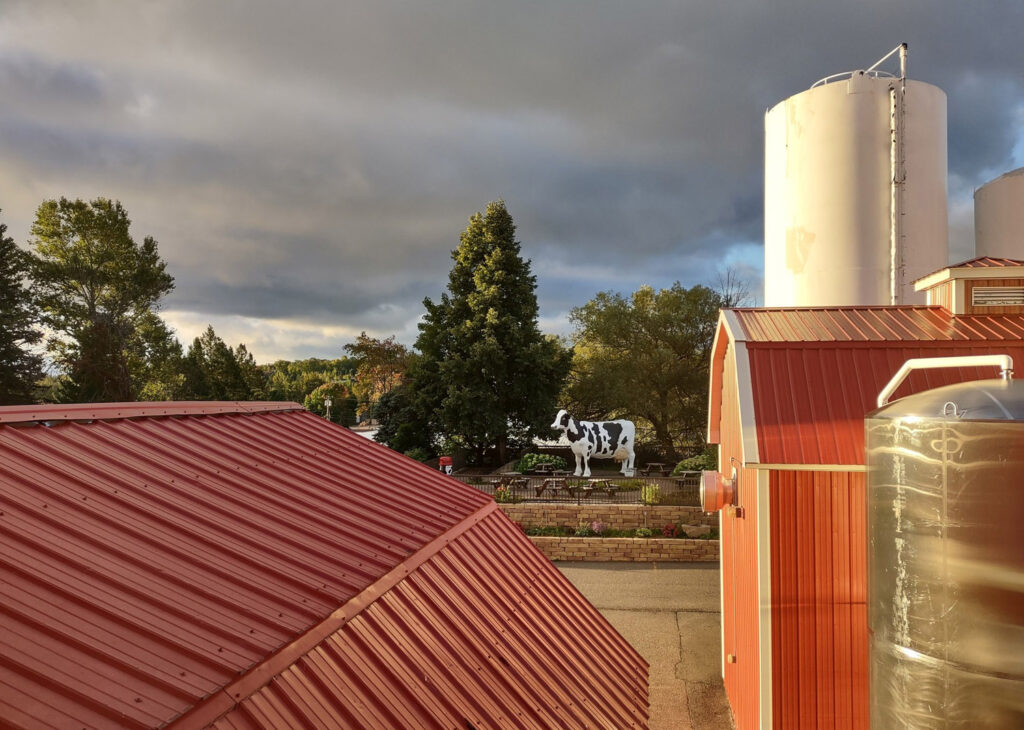 Sunrise over Jillbert's Dairy with silo and cow statue.