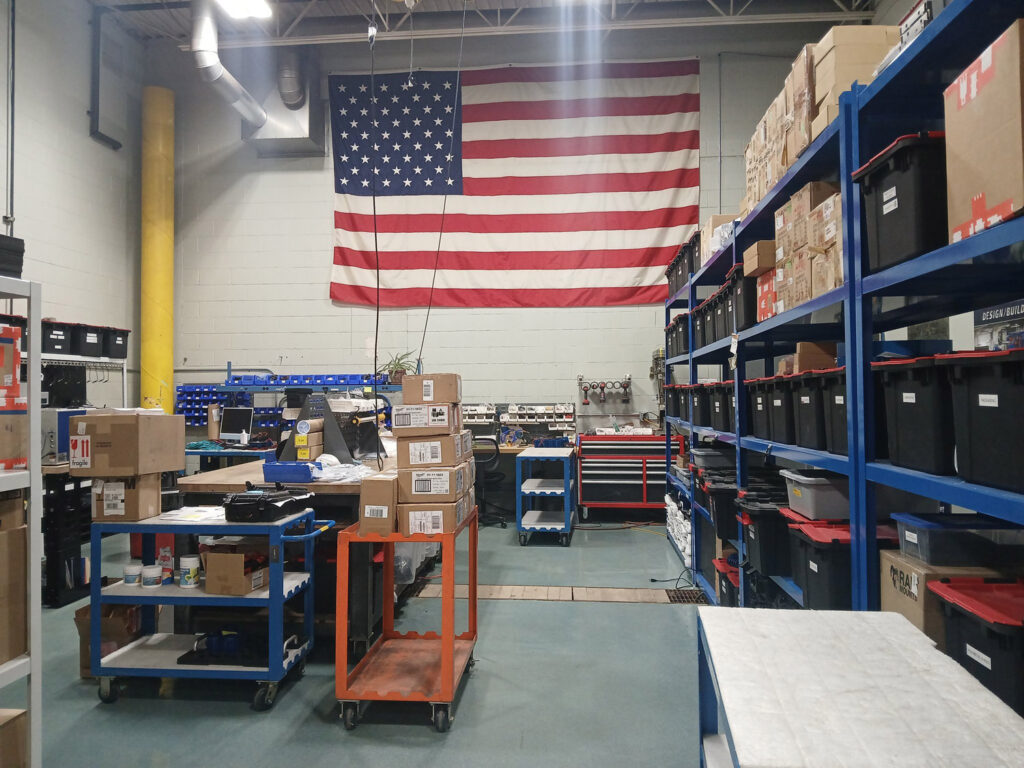 View of factory inside with American flag on wall.