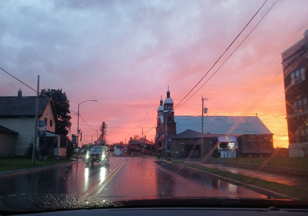 Sunset view of church with street from car.