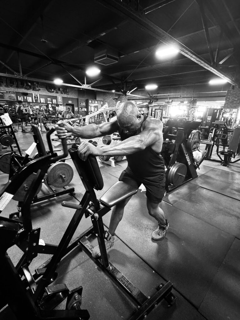 Man using weight machine.