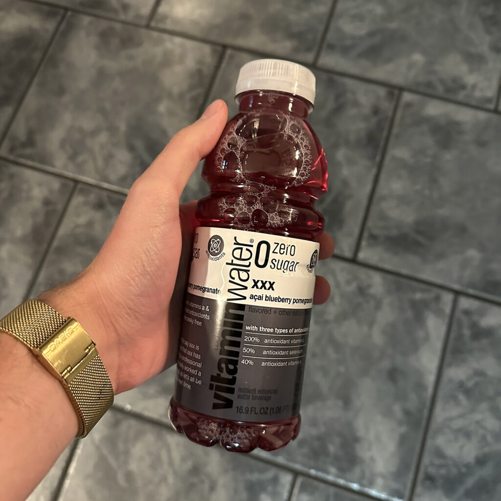 Vitamin water zero sugar bottle in man's hand.