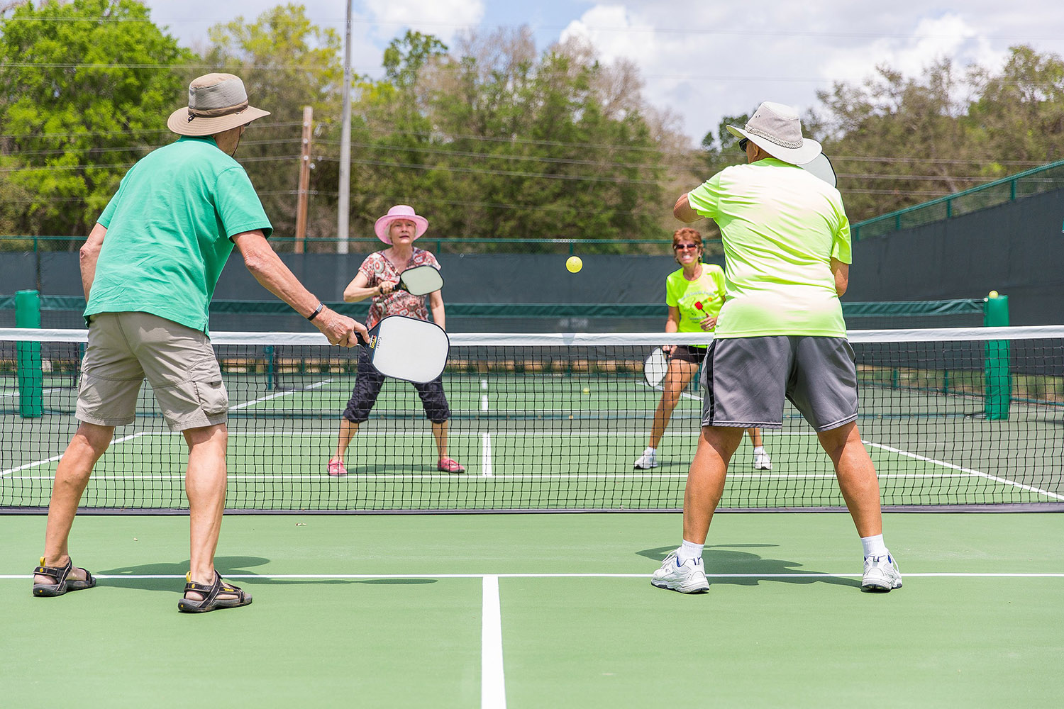 Four people playing pickleball.