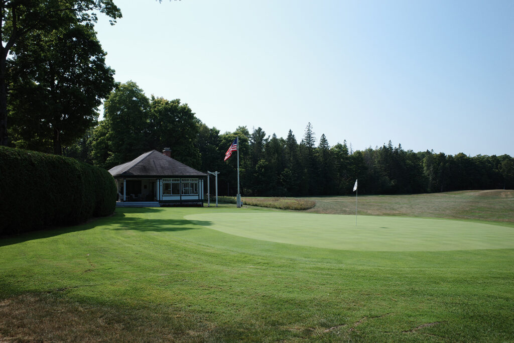 Golf course green with american flag.