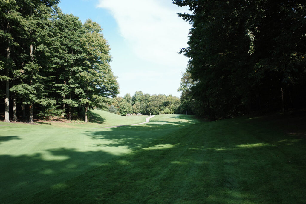 Golf fairway with tree shadows.