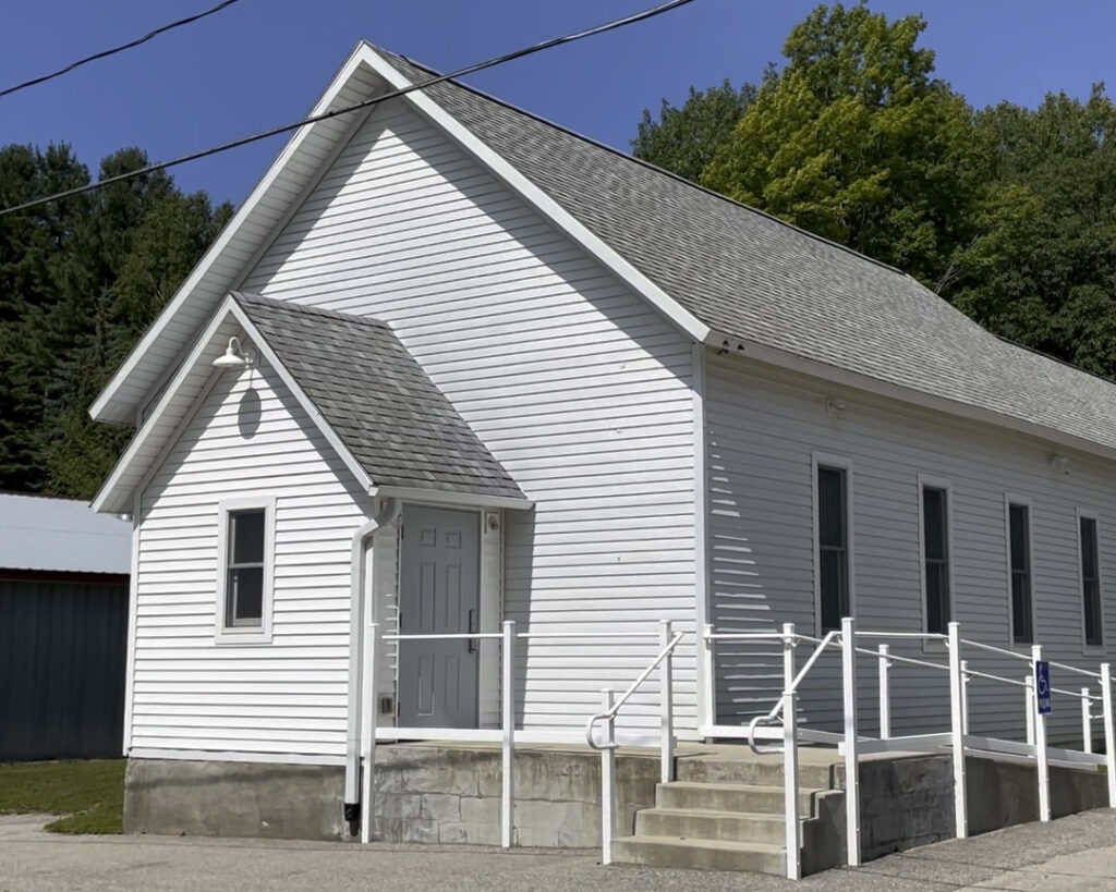 White one room schoolhouse building.