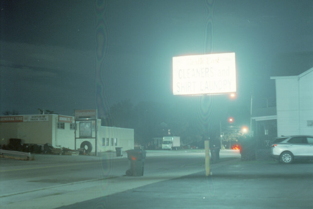 Eerie nighttime street scene with distortion in image.