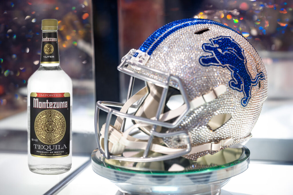 Detroit lions rhinestone decorative helment with Montezuma Tequila bottle photoshopped in next to it.