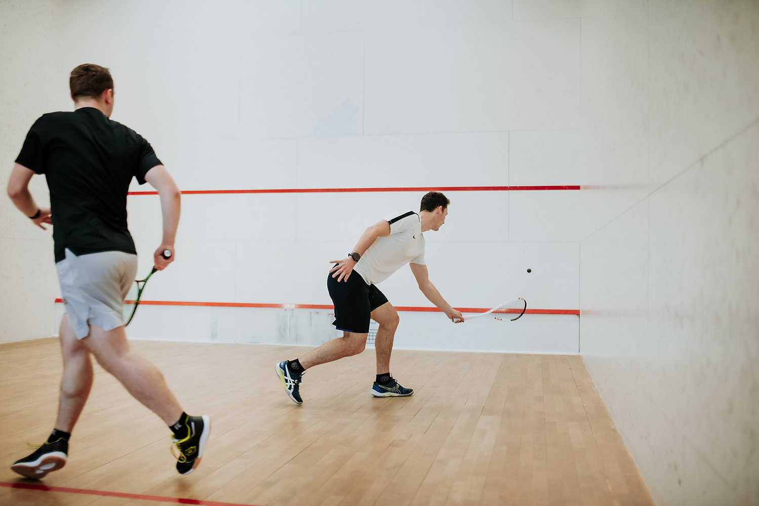 Two men playing squash.