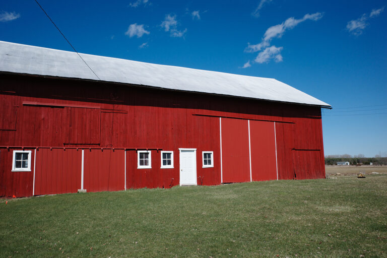 Red barn in field.