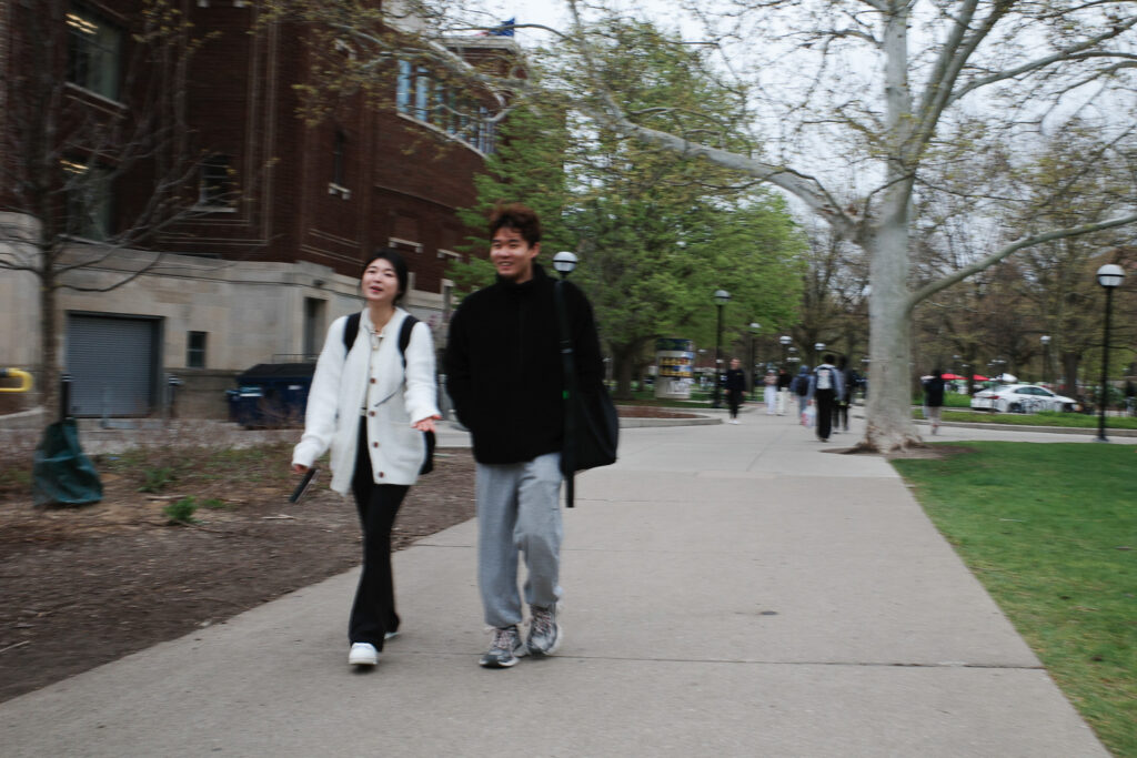 Two students walking on campus.