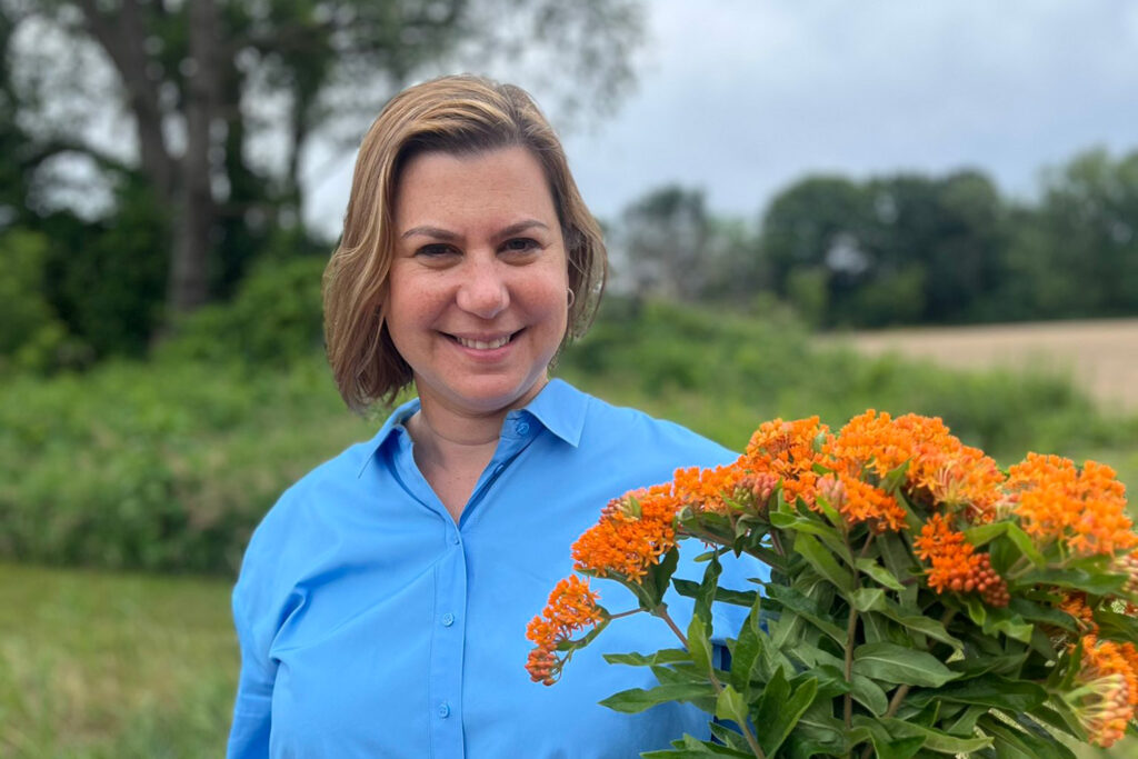 Slotkin holding flowers on farm.