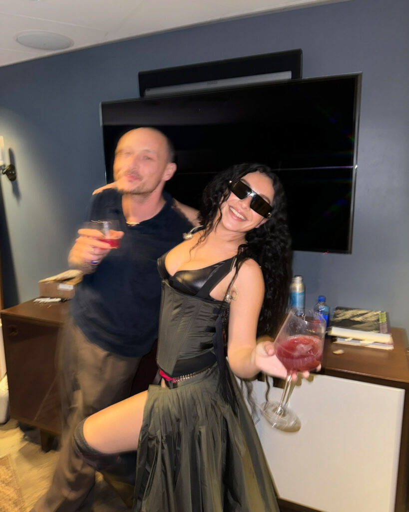 Charli XCX with man and glass of wine