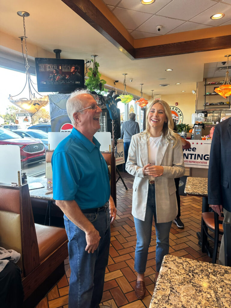 Rylee Linting and old man laughing in diner