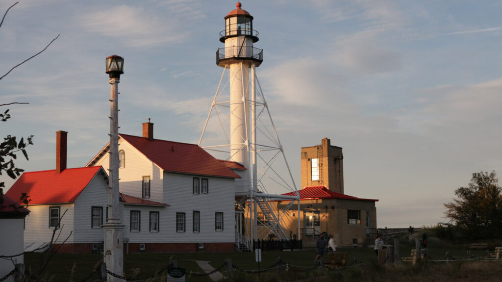 Old white lighthouse with red roof