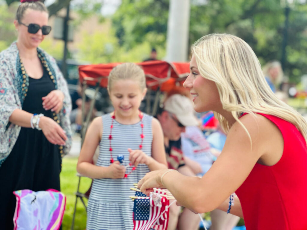 Rylee Lintng smiling at campaign event with mother and daughter